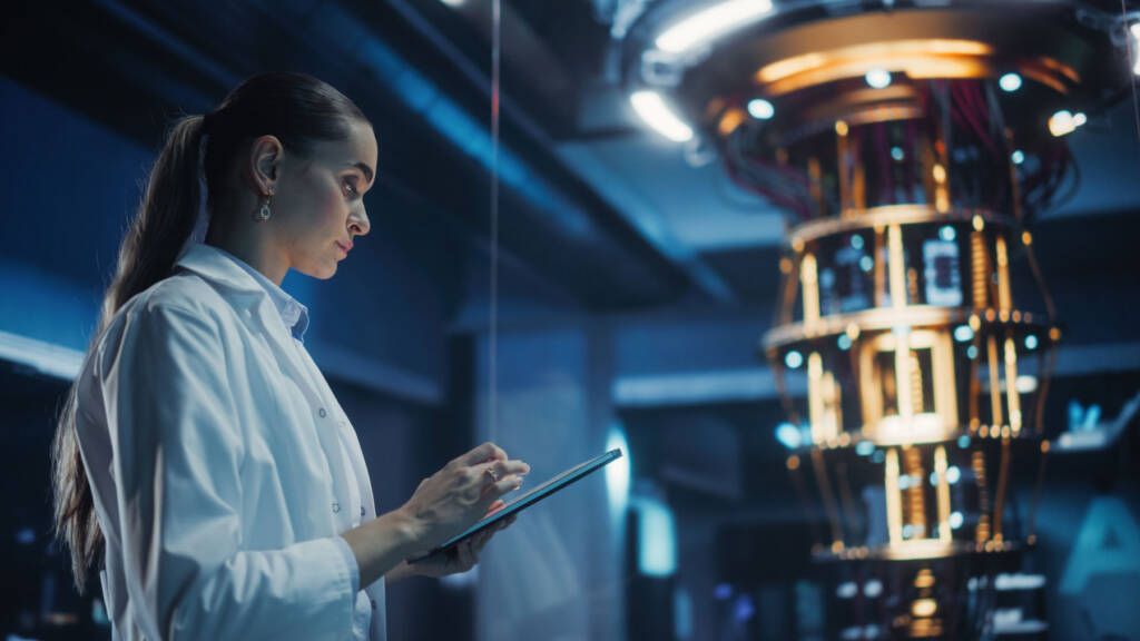 Scientist using tablet next to advanced lab instrument, representing machine learning and predictive analytics in modern LIMS